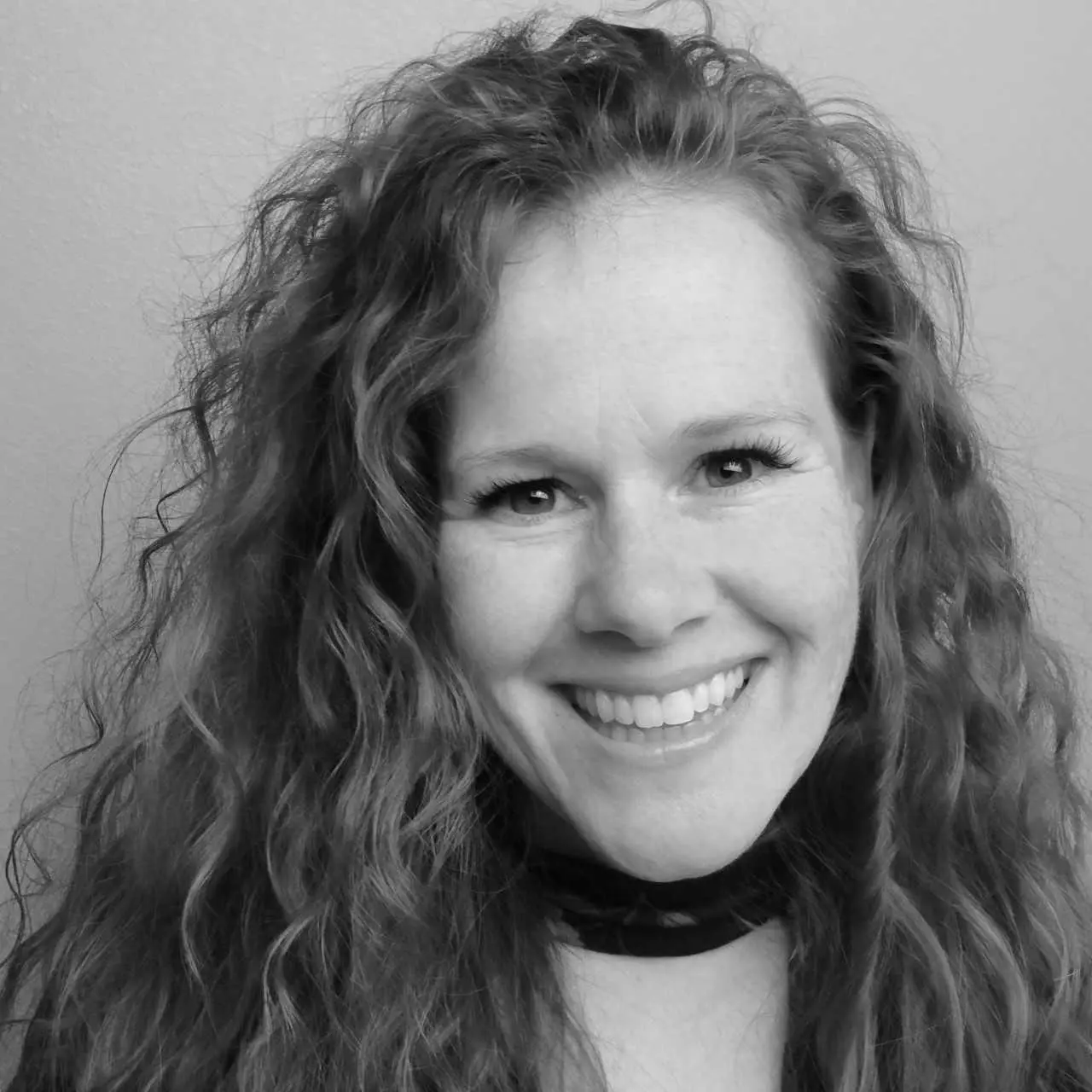 Black and white photo of Kim smiling