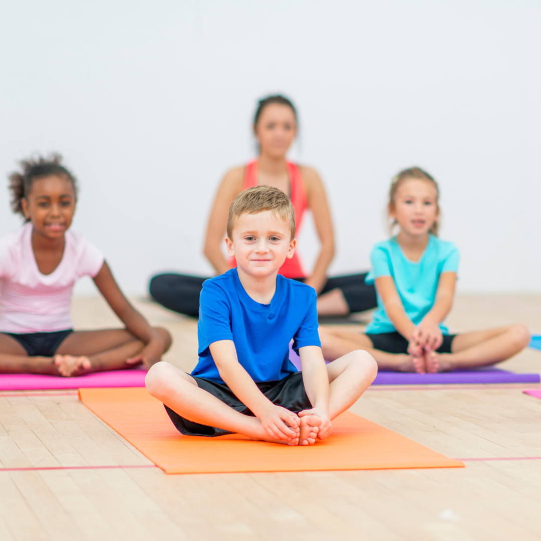 Boys and girls stretching on yoga mat
