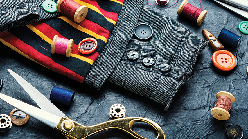 Different fabric with spools of thread and scissors