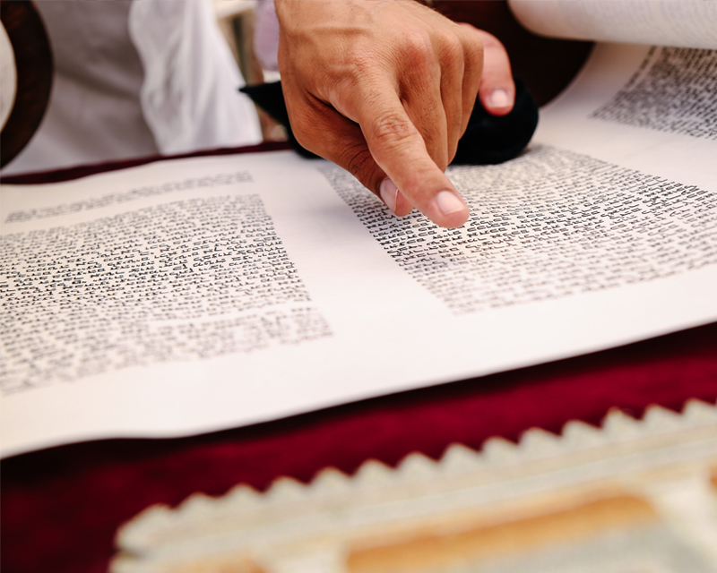 Person reading a Torah