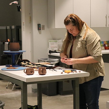 Woman handbuilding clay