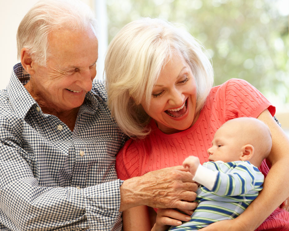 Grandparents holding their infant grandchild