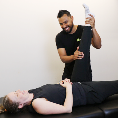 A specialist helping client to stretch