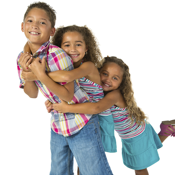Three siblings hugging each other