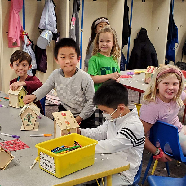 Boys and girls making bird houses.