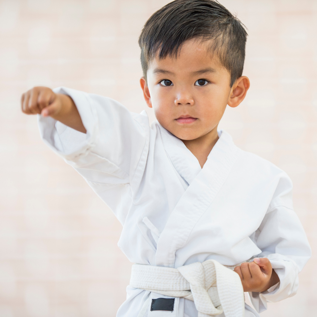 Boy in Taekwondo uniform with his fist out