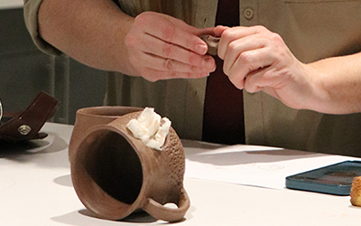 Hands working with clay