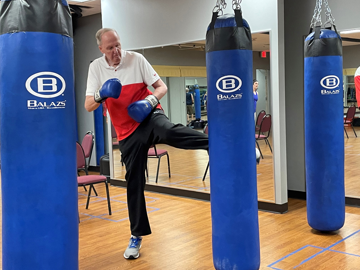 Man kicking punching bag