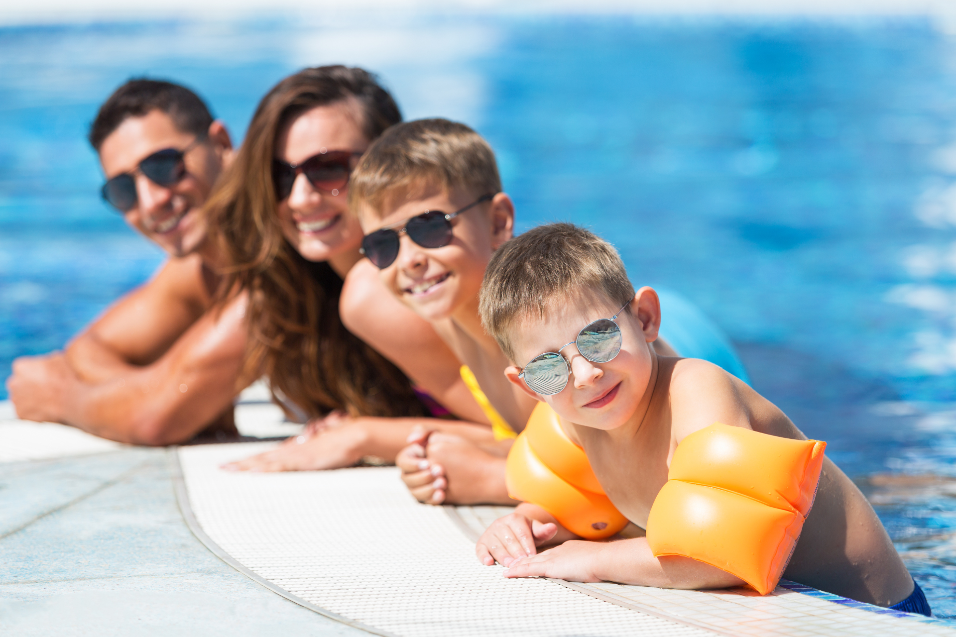 Family smiling in the pool