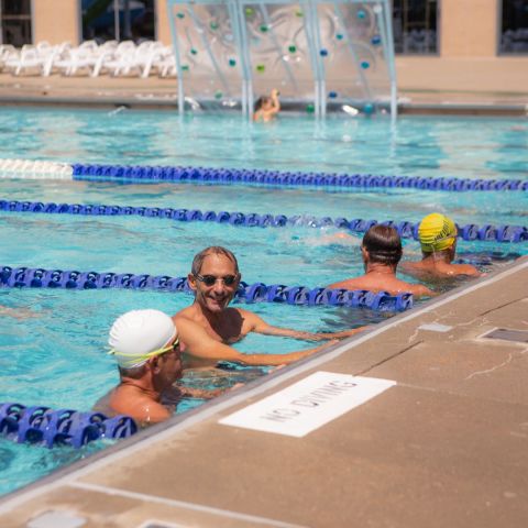 Man smiling while in the outdoor pool