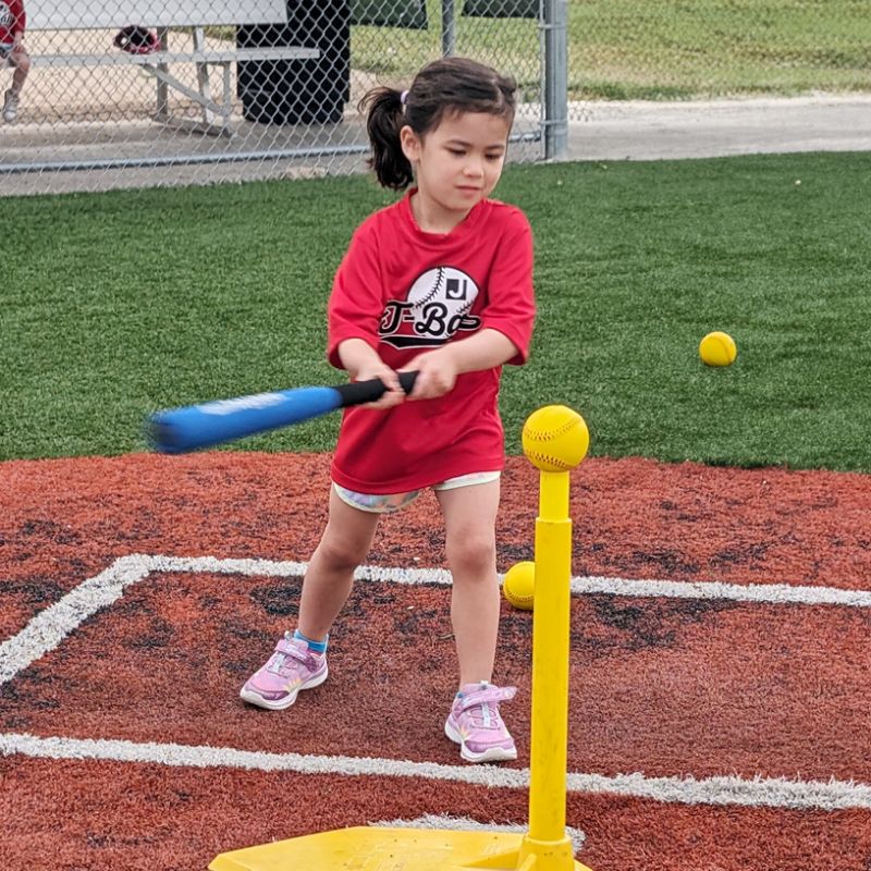 Two preschool boys wearing aprons mixing ingredients