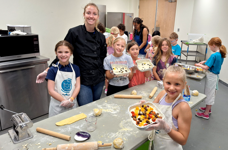 Campers making bread with staff