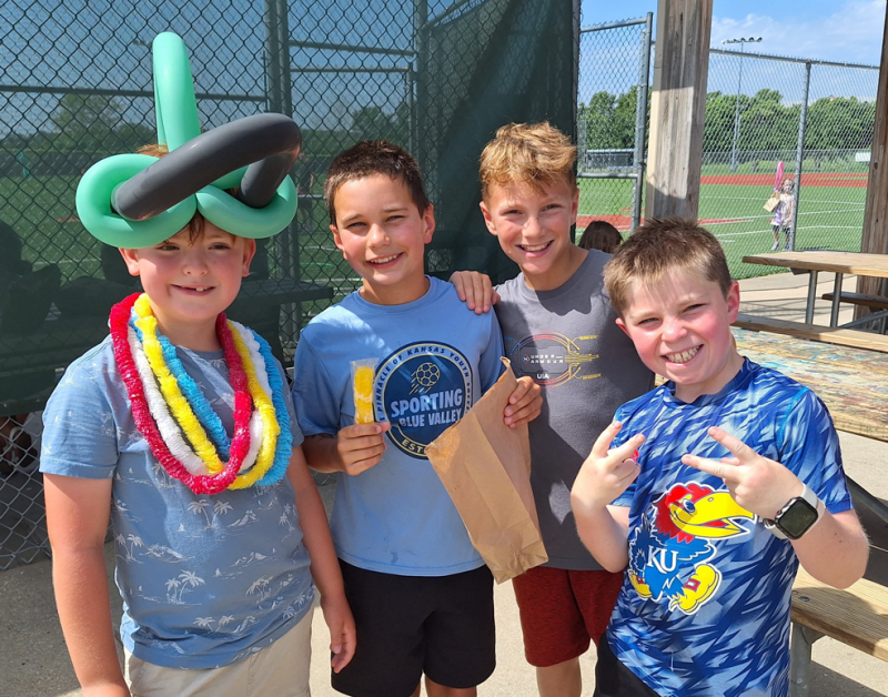 Boys smiling with popsicles at J Camp.