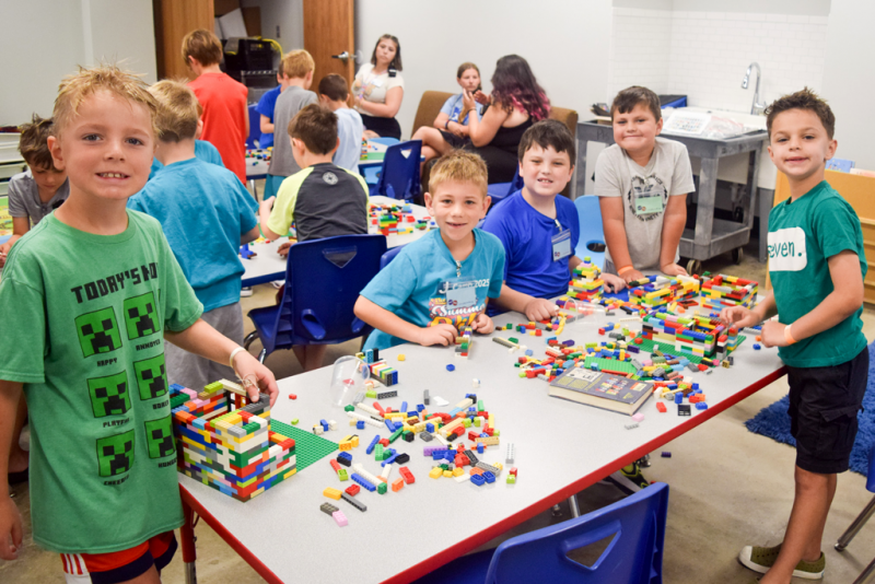 Campers posing with Lego creations