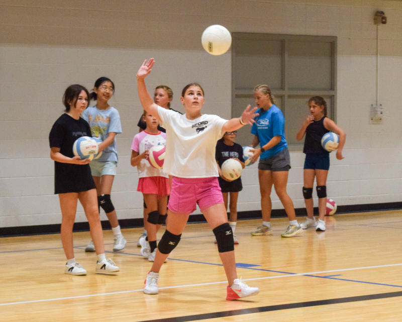 Girl serving a volleyball