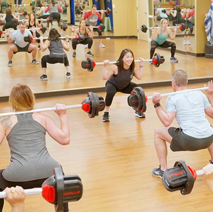 Group fitness class with weights