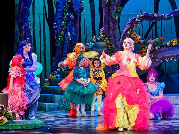 Photo of theatre performance with faeries in bright colored costumes