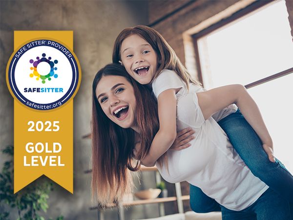 Teenage girl giving little girl a piggy back ride