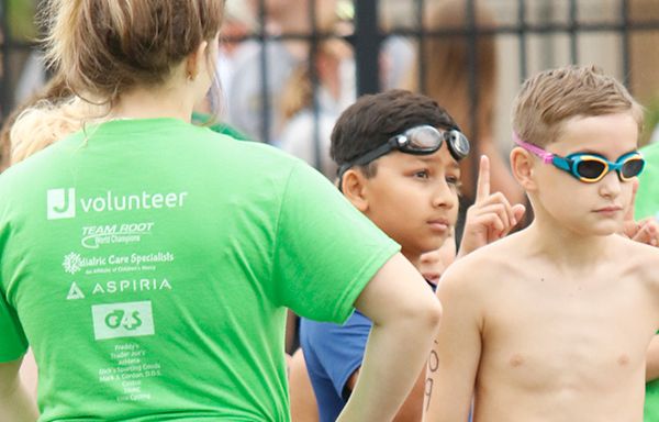 A volunteer waits to tell the next in line when he can begin his swim.